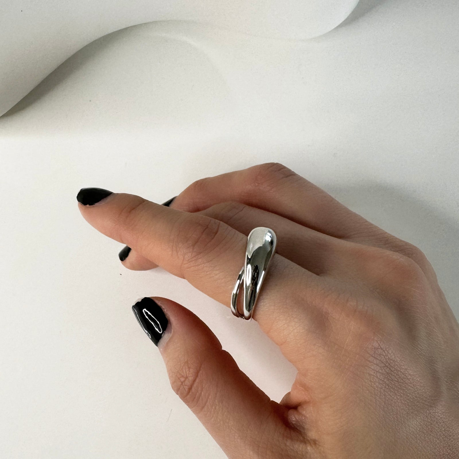 Model wearing silver dome cut out ring that's rhodium plated