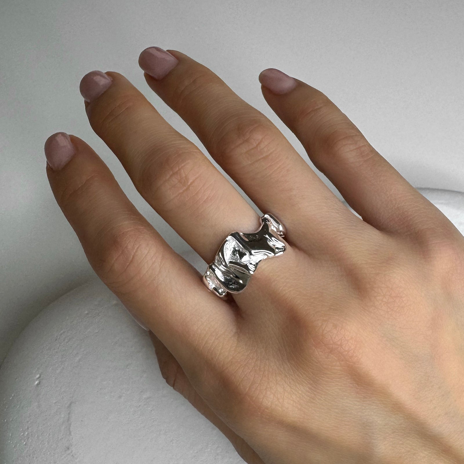 Model hand view of Abstract Wrinkle Ring. This silver ring has an organic shape, adjustable and made with genuine 925 sterling silver. 