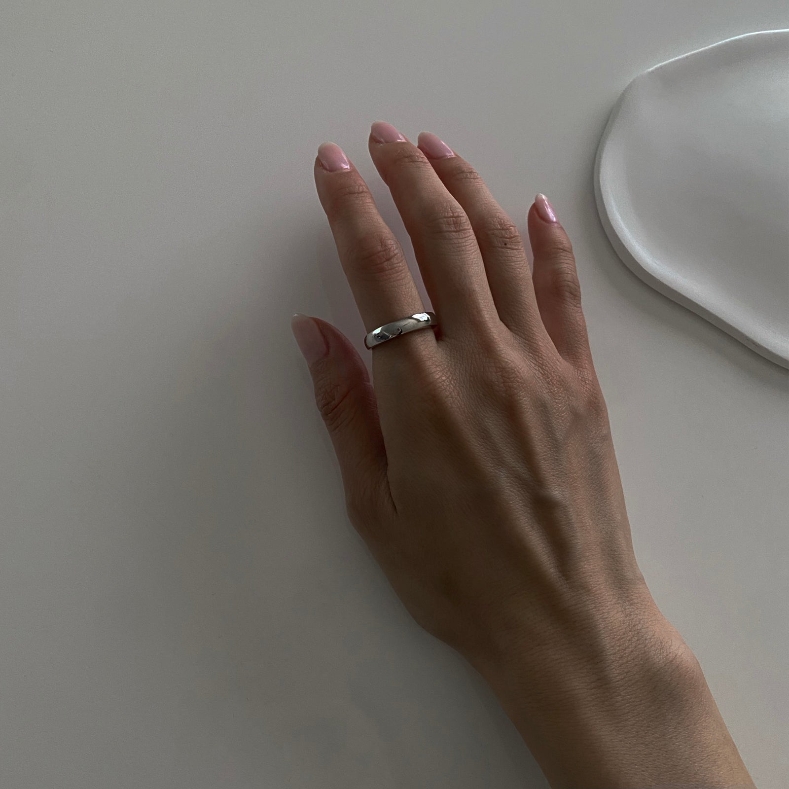 Simple classic band ring made of 925 sterling silver with rhodium plating for extra strength. The ring is adjustable and can fit most sizes 5-9 approximately. Perfect ring for everyday and looks great layered. 