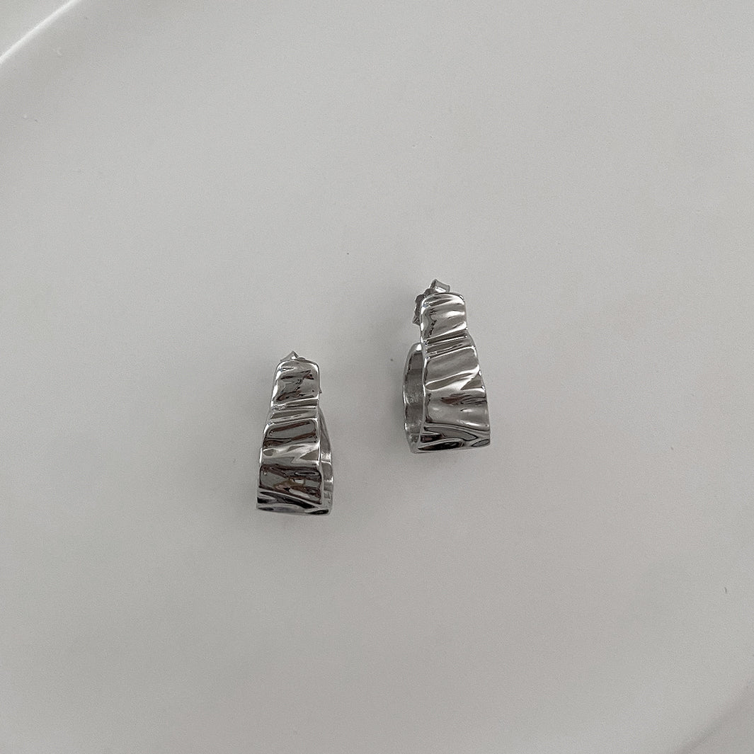 Front view of the Crinkle Earrings. Made of Sterling Silver 925 and has rhodium plating. Uses a simple push back for closure. Unique, cool design that can be worn everyday.