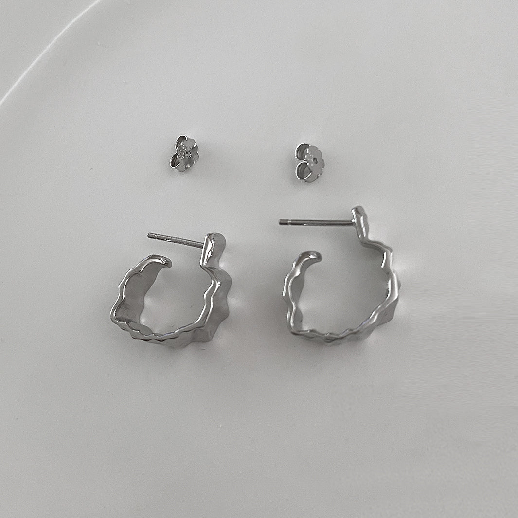 Open view of the Crinkle Earrings. Made of Sterling Silver 925 and has rhodium plating. Uses a simple push back for closure. Unique, cool design that can be worn everyday.